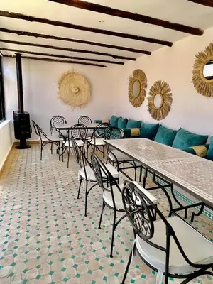 a group of tables and chairs in a room at Riad Jolie in Marrakech