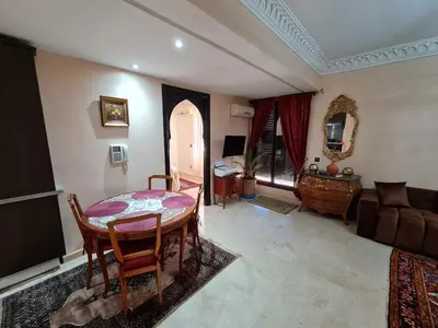 a living room with a table and a couch at Luxury apartment 2 in the heart of Gueliz, Wifi, Pool in Marrakech