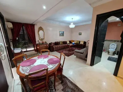 a living room with a table and a couch at Luxury apartment 2 in the heart of Gueliz, Wifi, Pool in Marrakech