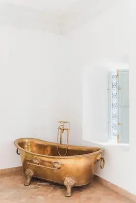 a copper tub in a bathroom with a window at Riad Vivre - Design Boutique Riad in Marrakech in Marrakech