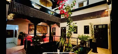 a house with a balcony with plants and flowers at Dar Najat in Marrakech
