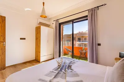 a bedroom with a bed and a large window at favorite in the city center - 100% Equipped in Marrakech