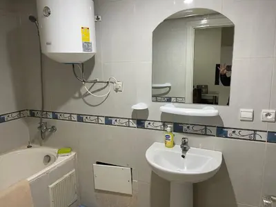 a bathroom with a sink and a mirror at Appartement 16 2èm étage ( POUR FAMILLE ) in Marrakech