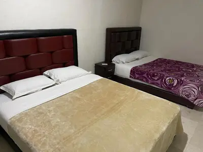 a bedroom with two beds and a bedskirts at Appartement 16 2èm étage ( POUR FAMILLE ) in Marrakech