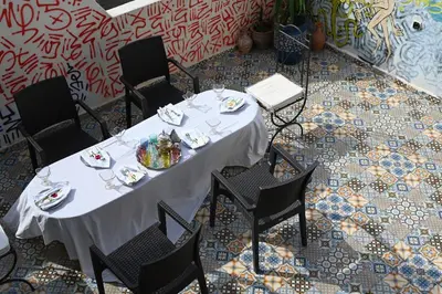 a table with a white table cloth on top of it at Riad sarsar airport in Marrakech