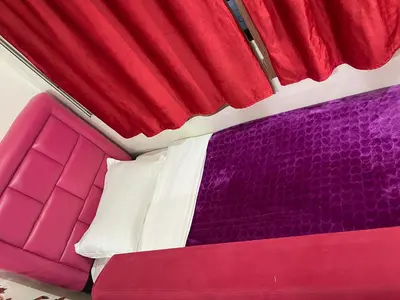 a red white and purple bed on a train at Appartement 18 3èm étage avec balcon ( POUR FAMILLE ) in Marrakech