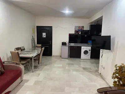 a living room with a table and a dining room at Appartement 20 3èm étage avec balcon ( POUR FAMILLE ) in Marrakech