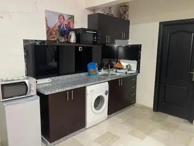 a small kitchen with a washer and dryer in it at Appartement 20 3èm étage avec balcon ( POUR FAMILLE ) in Marrakech