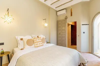 a bedroom with a large white bed with pillows at Riad XO in Marrakech