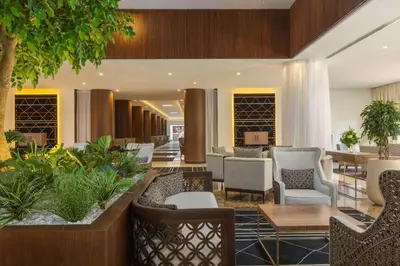 a lobby of a hotel with chairs and tables at Le Meridien N'fis in Marrakech