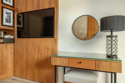 a dressing table with a mirror and a lamp at Le Meridien N'fis in Marrakech