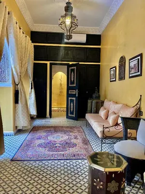a living room with a couch and a rug at Riad Ta'achchaqa in Marrakech