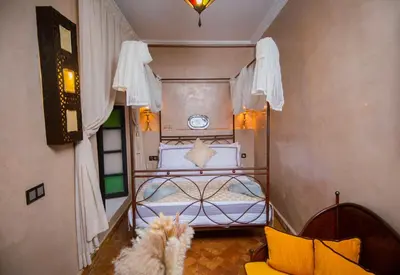 a small room with a bed and a window at Riad Ta'achchaqa in Marrakech
