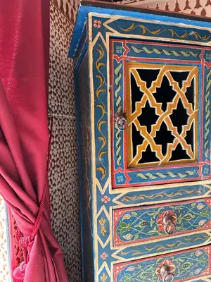 a colorful box sitting next to a red curtain at Riad Shaden in Marrakech