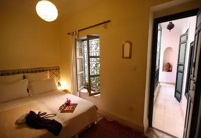 a bedroom with a bed with a tray on it at Dar Touyir in Marrakech