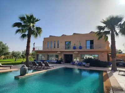 a house with a swimming pool in front of a house at Villa de rêve à Marrakech in Marrakech