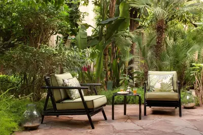 two chairs and a table in a garden at Les Jardins De La Médina in Marrakech
