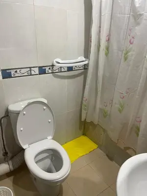 a bathroom with a toilet and a shower curtain at Appartement 23 4èm étage avec balcon ( POUR FAMILLE ) in Marrakech