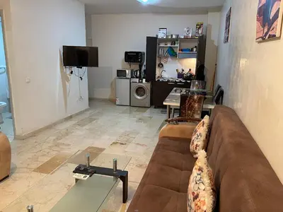 a living room with a couch and a table at Appartement 23 4èm étage avec balcon ( POUR FAMILLE ) in Marrakech