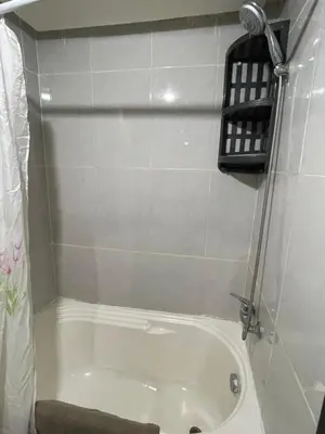 a bathroom with a bath tub with a shower at Appartement 24 4èm étage avec balcon ( POUR FAMILLE ) in Marrakech