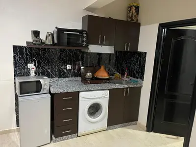 a kitchen with a washing machine and a washer at Appartement 26 au 4ème étage avec balcon ( POUR FAMILLE ) in Marrakech