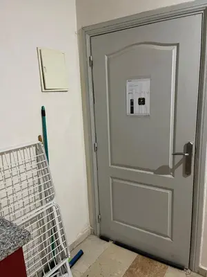 a gray door in a room with a broom at Appartement 27 au 4ème étage ( POUR FAMILLE ) in Marrakech