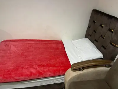a small bed with a red blanket on it at Appartement 27 au 4ème étage ( POUR FAMILLE ) in Marrakech