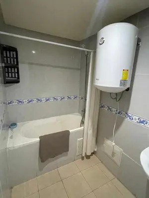 a bathroom with a tub and a toilet and a sink at Appartement 28 au 4 éme étage avec balcon ( POUR FAMILLE ) in Marrakech