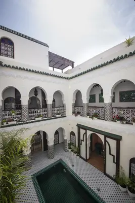 an external view of a building with a swimming pool at Riad Maison Belbaraka in Marrakech