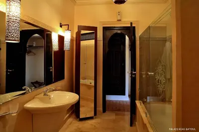 a bathroom with a sink and a toilet and a shower at Riad Marrakech By Hivernage in Marrakech