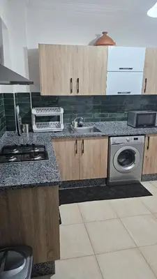 a kitchen with a sink and a washing machine at Bitty Apartment in Marrakech