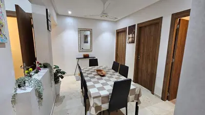 a dining room with a table and chairs at Bitty Apartment in Marrakech