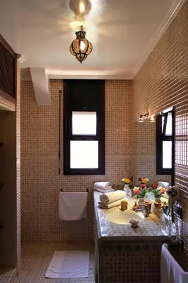 a bathroom with a sink and a window at Palais Dar Ouladna in Marrakech