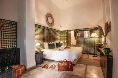 a hotel room with a bed and a mirror at Riad Palais Calipau in Marrakech