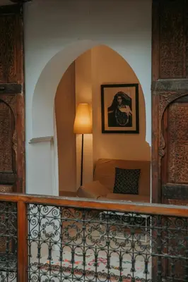 a living room with a couch and a lamp at Riad Djebel in Marrakech