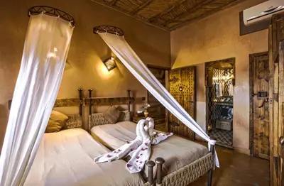 a bedroom with a bed with a curtain on it at Hotel Kasbah Le Mirage & Spa in Marrakech
