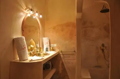 a bathroom with a sink and a mirror at Riad Adriana in Marrakech
