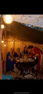 a group of people sitting at a table in a room at La Ferme des Tipis Marrakech in Marrakech