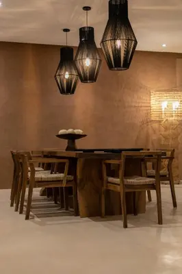 a dining room with a table and chairs and lights at Villa Ecolodge DAR LOUMA in Marrakech