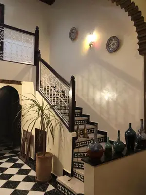 a room with a staircase with vases on the wall at Riad Jasmine in Marrakech