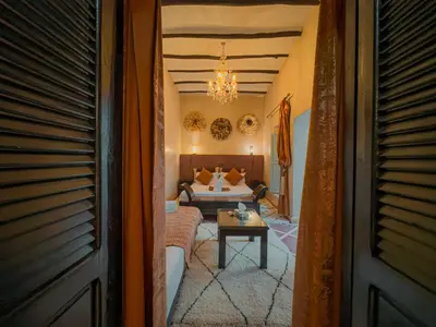 a living room with a couch and a bed at Riad L'Orchidée Suites & Spa in Marrakech