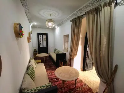 a living room with a couch and a table at Riad Dowaya in Marrakech