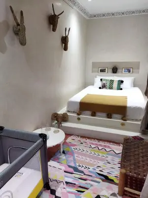 a bedroom with a bed and a rug at Riad Dowaya in Marrakech