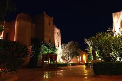 a building with a clock tower at night at La Maison Des Oliviers in Marrakech