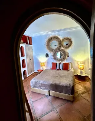 a bedroom with a bed with a large mirror at Riad Lauriers Blancs in Marrakech