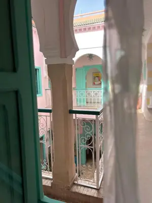 a view of a balcony from a window of a building at Riad Lauriers Blancs in Marrakech