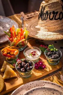 a table with bowls of food and plates on it at Riad Dar Beldia and Spa in Marrakech