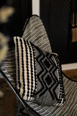 a black and white bag sitting on a chair at Riad Dar Beldia and Spa in Marrakech
