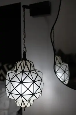 a chandelier hanging in front of a mirror at Riad Dar Beldia and Spa in Marrakech