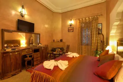 a bedroom with a large bed with towels on it at Villa Dar Mya Palmiers in Marrakech